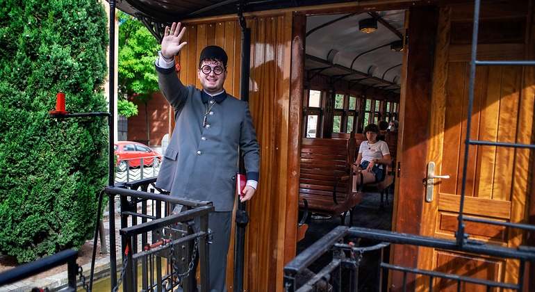Revisor se despide de aquellos que se han quedado en tierra desde la pasarela final del tren de la fresa